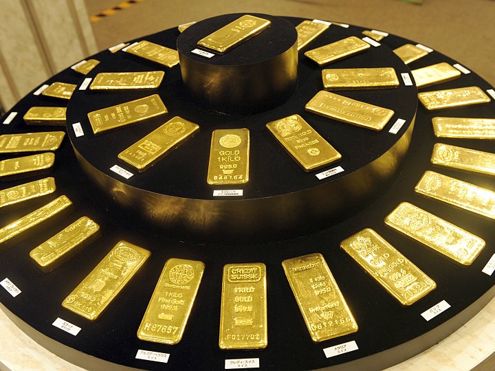 Gold ingots from various countries are displayed in Tokyo. Voices warning against investing in gold at its present price per ounce are getting more insistent. (Yoshikazu Tsuno/AFP/Getty Images)
