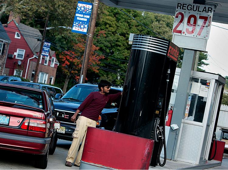 A service station attendant pumps gasoline at $2.97 a gallon in Teaneck, New Jersey. (Chris Hondros/Getty Images)