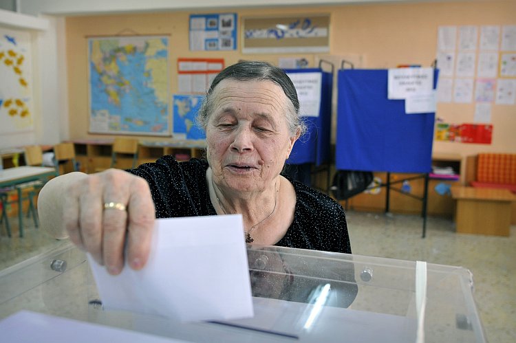 A woman casts her vote for  Greece's general elections