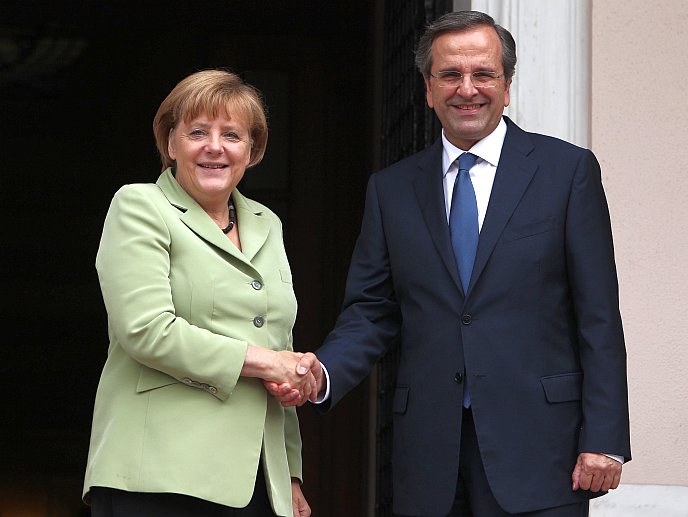  Greek Prime Minister Antonis Samaras (R) and German Chancellor Angela Merkel shake hands at the Maximos Mansion in Athens on Oct. 9. Merkel told Greece that the 