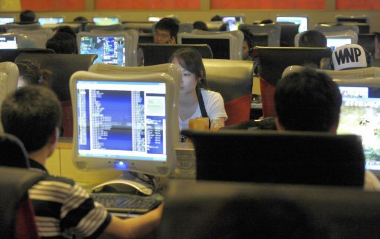People use computers at an internet bar in Beijing on June 3, 2009. Criticisms of China's Green Dam Internet filtering software has been banned. (Liu Jin/AFP/Getty Images)
