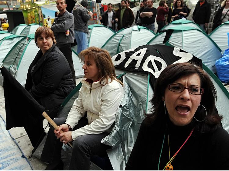 Textile workers shout slogans next to their tents on the third day of a protest camp at the Ministry of Finance in Athens, April 1, 2009.  (Louisa Gouliamaki/AFP/Getty Images)