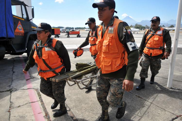 Members of the Humanitarian and Rescue Unit (UHR) of the Guatemalan Army prepare to leave to Haiti, on January 13, 2010 in Guatemala City. Planeloads of rescuers and relief supplies headed to Haiti today. (Johan Ordonez/AFP/Getty Images)