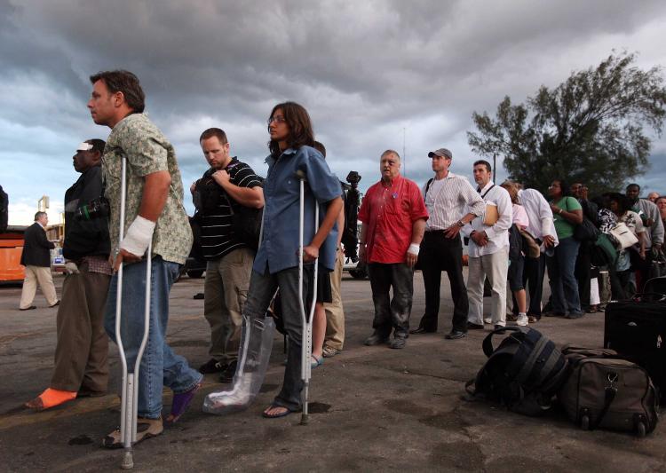 People line up on the tarmac of the Port-au-Prince airport to be evacuated by the U.S. Coast Guard on January 13, 2010 in Port-au-Prince, Haiti.  (Joe Raedle/Getty Images)