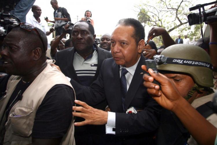 Former Haitian dictator Jean-Claude 'Baby Doc' Duvalier(C) arrives at the prosecutors office in Port-au-Prince Januay 18, 2011.  (Hector Retamal/AFP/Getty Images)