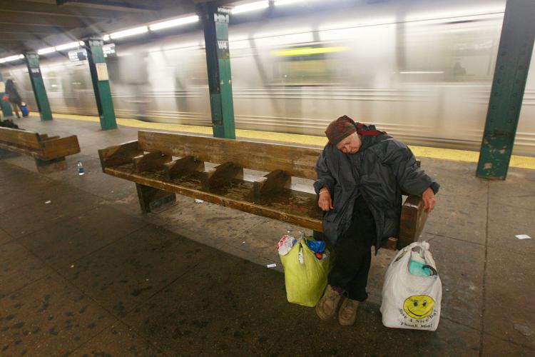 A woman sleeps on a subway platform in New York City. According to NYC poverty advocates, the U.S. Census Bureau's latest statistics do not accurately account for New York's homeless population. (Mario Tama/Getty Images)