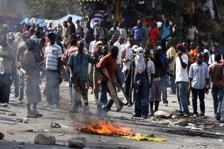 Men protest in the streets of Petion-Ville on December 8, 2010. (Hector Retamal/AFP/Getty Images)