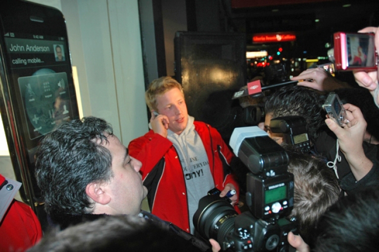 New Zealander Jonny Gladwell is the first person to buy an Apple iPhone 3G after a bet from his friends that he wouldn't last the time in the queue. (Salina Wang/The Epoch Times)