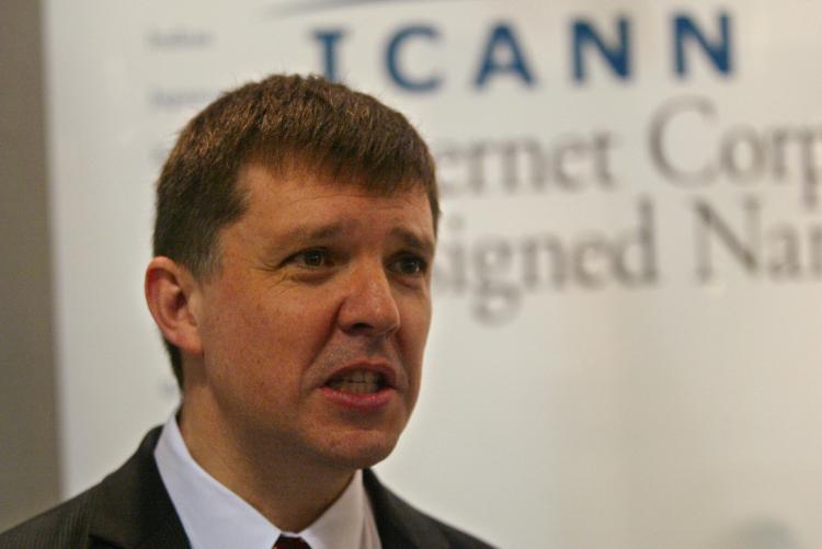 In this file photo, Internet Corporation for Assigned Names and Numbers (Icann) CEO Paul Twomey answers a visitor's question at the Icann stand of the World Summit on the Internet Society (WSIS). Icann has approved non-Latin languages for use in domain na (Abdelhak Senna/AFP/Getty Images)