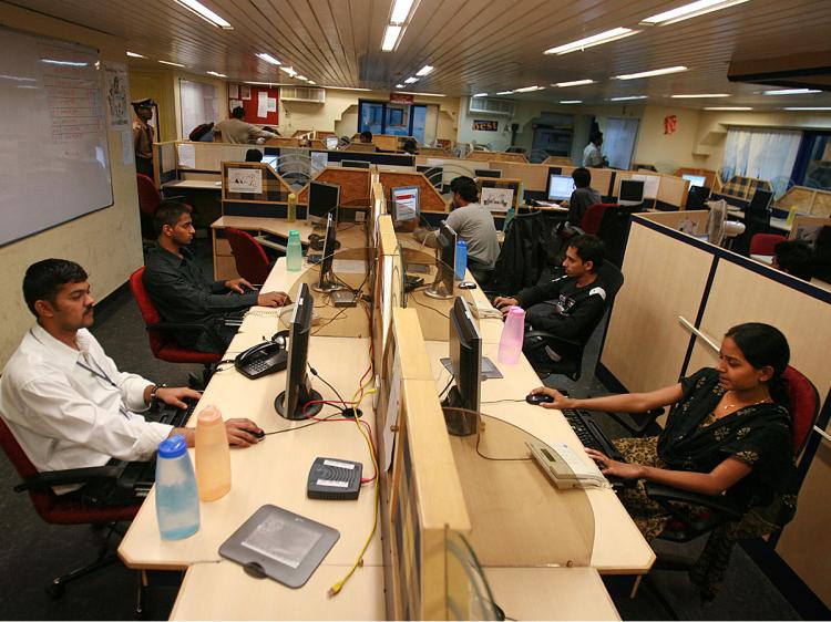 Tutors work at TutorVista headquarters in the early morning in Bangalore, India, tutoring students in English-speaking countries.   (Uriel Sinai/Getty Images)