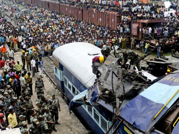 FATAL COLLISION: Rescue personnel in India conduct recovery operations on the mangled wreckage of a train following a railway accident in Sainthia, some 162 miles north of Kolkata, on July 19. (Deshakalyan Chowdhury/AFP/Getty Images)