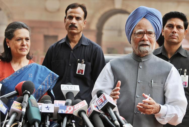 Congress President and UPA Chairperson Sonia Gandhi (2L) looks on as Indian Prime Minister Manmohan Singh (C) addresses media representatives in New Delhi on May 20, 2009, after they met Indian President Pratibha Patil to stake their claim to form the Gov (Raveendran/AFP/Getty Images)