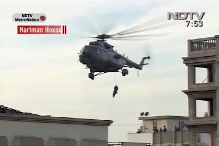 This television grab from Indian channel NDTV shows military personnel as they abseil from a helicopter onto a roof of a building in Mumbai early November 28, 2008. (STR/AFP/Getty Images)