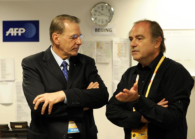 IOC President Jacques Rogge chats with Agence France-Presse Sports department head , Pierre Pointeau (R), the day before the IOC and Beijing Olympic officials cancelled a daily news briefing following days of hard questions about Olympic controversies.  (Olivier Morin/AFP/Getty Images)