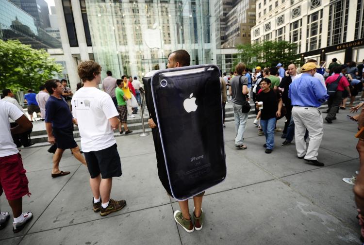 An iPhone-dressed man stands outside Manhattan's 5th Avenue Apple store as latest-generation iPhone,called the iPhone4, makes its debut in New York. The iPhone 4, which boasts video chat, high-definition video and sharper screen resolution  (Emmanuel Dunand/AFP/Getty Images)