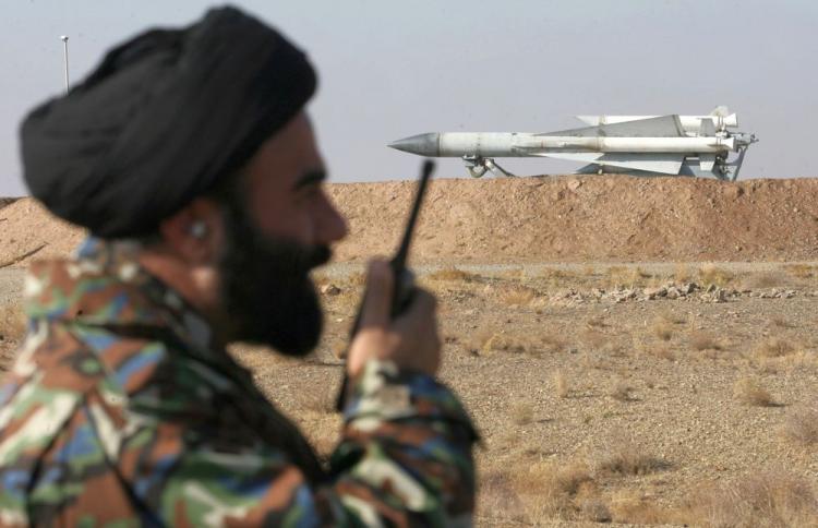 An Iranian army cleric monitors an area as he stands near a S-200 surface-to-air missile during military maneuvers in Iran on Nov. 26, 2009 during a previous launch.  (Ali Shayegan/AFP/Getty Images)