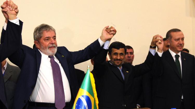 L to R: Brazilian President Luiz Inacio Lula da Silva, Iran's President Mahmoud Ahmadinejad and Turkish Prime Minister Recep Tayyip Erdogan pose with their hands together after the Islamic republic inked a nuclear fuel swap deal in Tehran on May 17. (Atta Kenare/Getty Images)