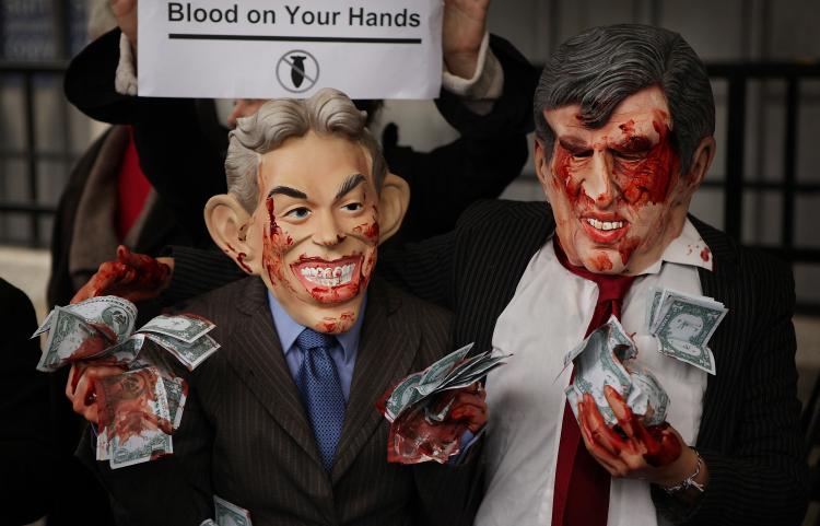 Anti-war demonstrators dressed up as bloodied former Prime Minister Tony Blair (L) and Prime Minister Gordon Brown stand outside the Iraq Inquiry on November 24, 2009 in London. (Peter Macdiarmid/Getty Images)