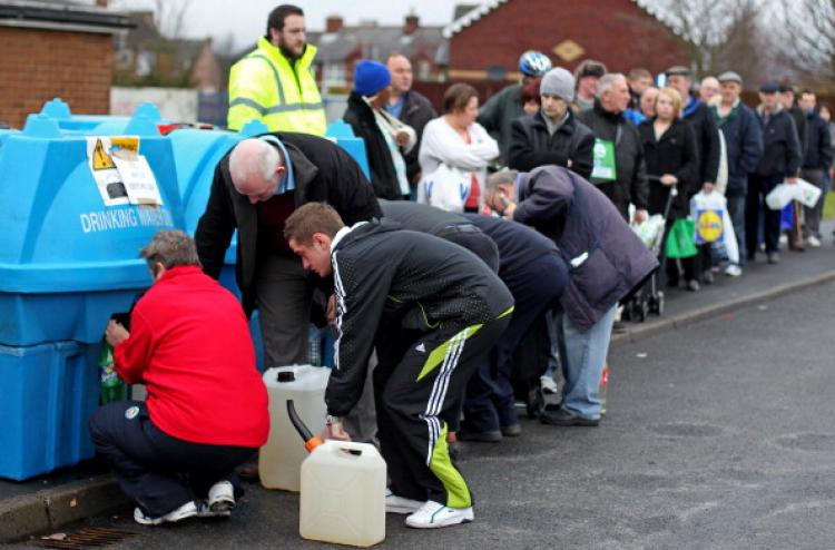 People queue to fill bottles and tanks with water at the Avoniel Leisure Centre in Belfast, Northern Ireland on December 29, 2010.  (Peter Muhly/AFP/Getty Images)
