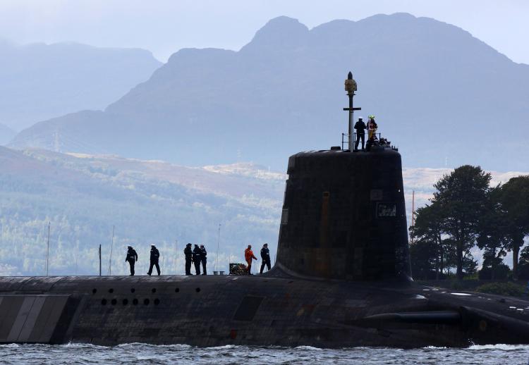 A Trident submarine makes it's way out from Faslane Naval base on September 23, 2009, in Faslane, Scotland. The new British prime minister will need to consider cutting the Trident missile-carrying submarines. (Jeff J Mitchell/Getty Images )