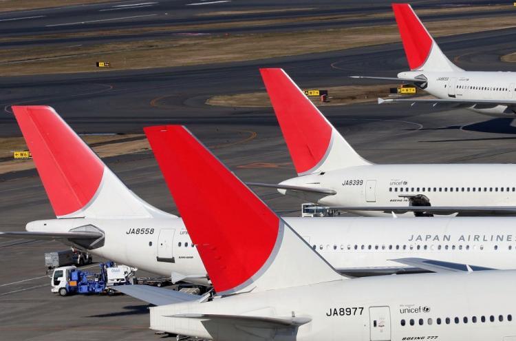 Japan Airlines (JAL) passenger planes sit on the tarmac of Tokyo International Airport on January 6, 2010 in Tokyo, Japan. (Koichi Kamoshida/Getty Images)