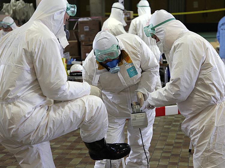 Radiation scanning crews check eath other's levels as they change their working shift at a screening centre in Koriyama in Fukushima prefecture, 60km west of TEPCO's striken Fukushima No.1 nuclear power plant, on March 18, 2011. (Go Takayama/AFP/Getty Images)
