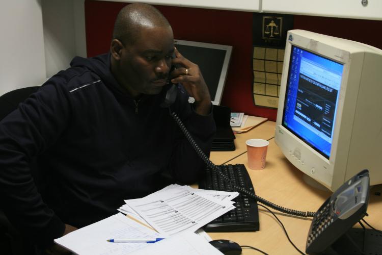 Jean Ronald Chery, a Haitian journalist who lives in New York, makes phone calls to fellow journalists in Port-au-Prince at the Committee to Protect Journalists office in New York. (Genevieve Long/The Epoch Times)