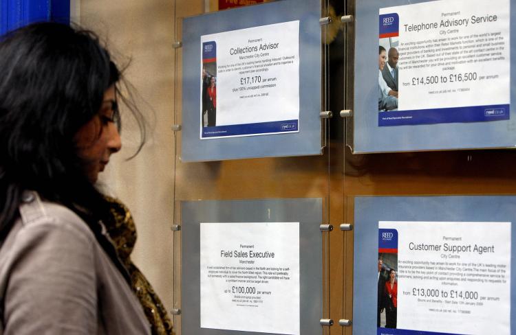 A woman looks at job advertisements in the window of a recruitment agency in Manchester, northwest England. The EU has proposed a micro finance facility to stimulate employment. (Paul Ellis/AFP/Getty Images)