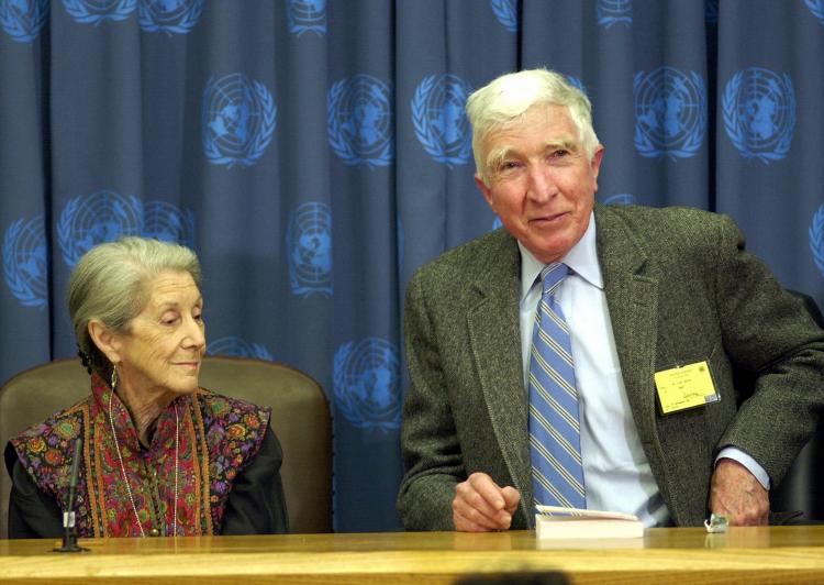 In this file photo, US author John Updike (R) speaks during a press conference at the United Nations in New York City. John Updike passed away at the age of 76. (MANDEL NGAN/AFP/Getty Images)