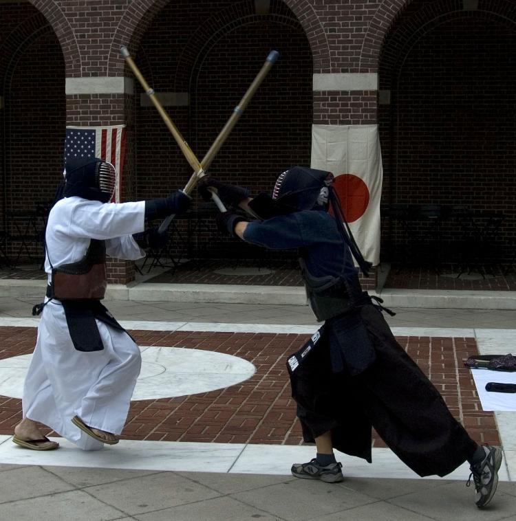 SAMURAI COMBAT: Kendo Master Shozo Kato demonstrates the traditional Japanese martial arts full-contact fencing for high school students this Thursday.  (Diana Hubert/The Epoch Times)