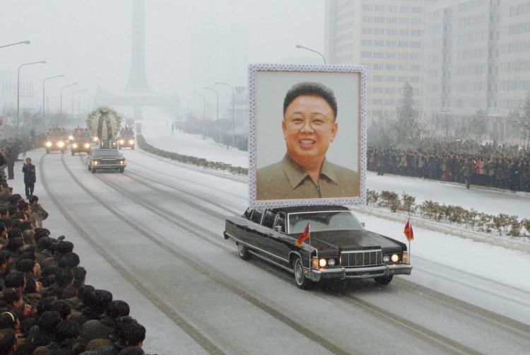 A car carries a portrait of Kim Jong-Il 