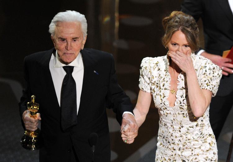 Actor Kirk Douglas (L) presents the Best Supporting Actress trophy to Melissa Leo (R) at the 83rd Annual Academy Awards. (GABRIEL BOUYS/AFP/Getty Images)