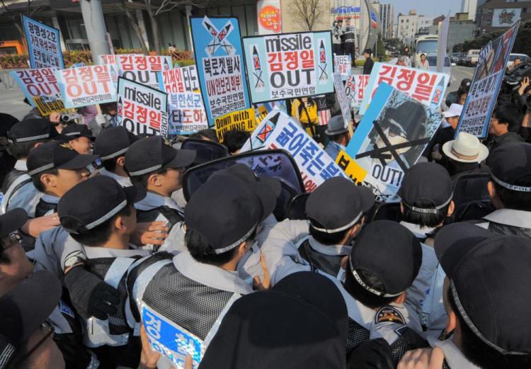 Conservative activists struggle with police officers during a protest rally against North Korea's launching of a long-range rocket, near the US embassy in Seoul on April 5, 2009. (Kim Jae-Hwan/AFP/Getty Images)