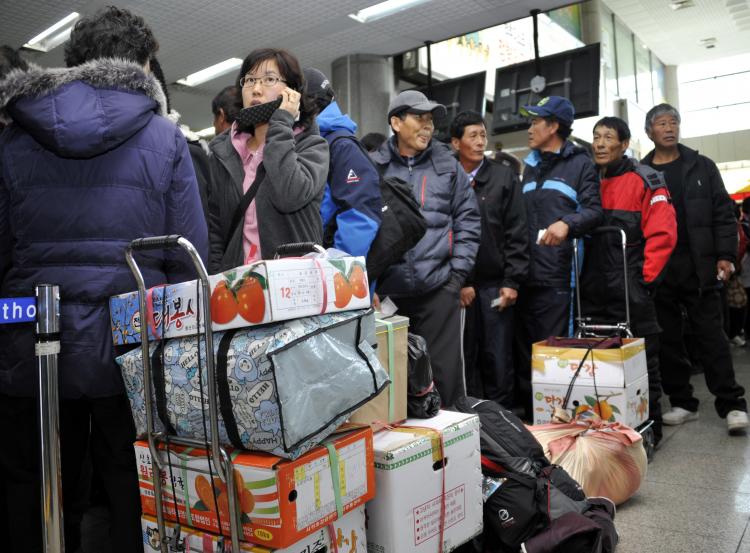 Yeonpyeong island residents and their relatives wait for a ferry to the island at the port in Incheon on November 25, 2010 as commercial ferry services resume two days after the island was shelled by North Korea. (Yoshikazu Tsuno/AFP/Getty Images) Yeonpyeong island residents and their relatives wait for a ferry to the island at the port in Incheon on November 25, 2010 as commercial ferry services resume two days after the island was shelled by North Korea. (Yoshikazu Tsuno/AFP/Getty Images)