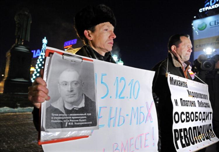 Two men hold a picture of jailed Russian tycoon Mikhail Khodorkovsky and posters reading '15.12.10 is a day of MBH (initials of Mikhail Borisovich Khodotkovsky). We are together!' (Yuri Kadobnov/AFP/Getty Images)