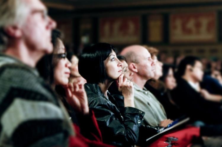 The audience attentively watches the Divine Performing Arts performance.   (Ma Youzhi/The Epoch Times)