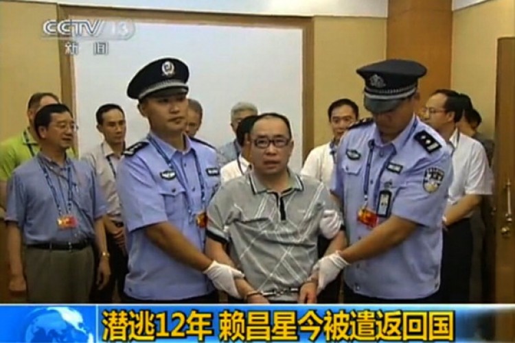 This TV grab, taken on July 23, 2011 from China's Central Television, shows fugitive Chinese businessman Lai Changxing escorted by Chinese authorities after he landed in Beijing aboard a civilian flight in the custody of Canadian police. (STR/AFP/Getty Images)