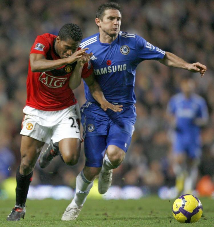  THE BATTLE: Chelsea midfielder Frank Lampard (right) vies with Manchester United's Antonio Valencia (L) at Stamford Bridge in London on Sunday. (Ian Kington/AFP/Getty Images)