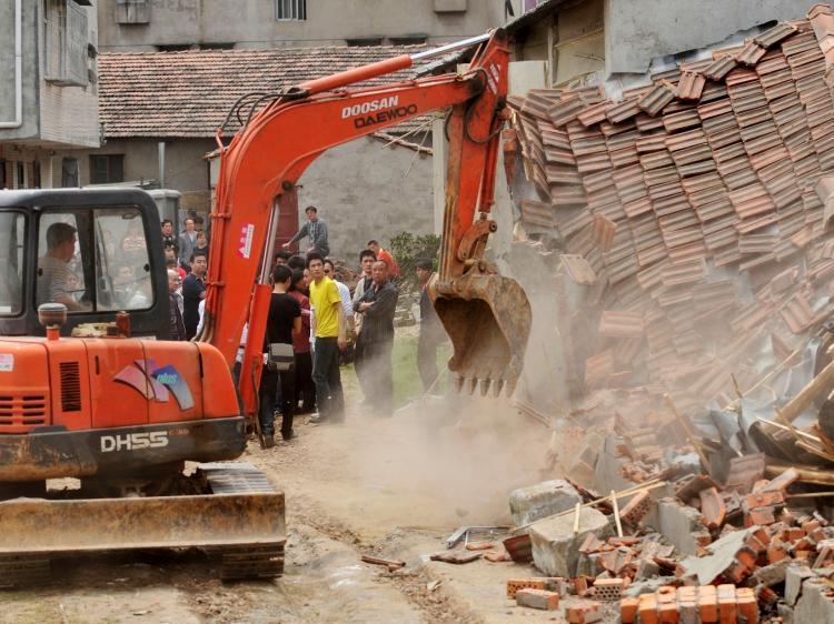 Chinese authorities demolish houses which are claimed illegal by the local government in Wuhan, central China's Hubei province on May 7, 2010. Land seizures have been a problem for years in China and forced evictions have not been uncommon. (STR/AFP/Getty Images))