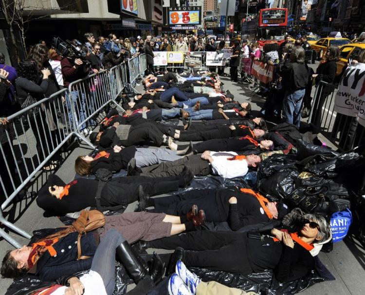 TIMES SQUARE 'LIE IN': Demonstrators with the group New Yorkers Against Gun Violence pretend to be dead as they lie down on the sidewalk in Times Square in New York on April 16 to try to get support for sensible guns laws. The group chose to hold the event on the second anniversary of the Virginia Tech shootings. (Timothy A. Clary/AFP/Getty Images) TIMES SQUARE 'LIE IN': Demonstrators with the group New Yorkers Against Gun Violence pretend to be dead as they lie down on the sidewalk in Times Square in New York on April 16 to try to get support for sensible guns laws. The group chose to hold the event on the second anniversary of the Virginia Tech shootings. (Timothy A. Clary/AFP/Getty Images)