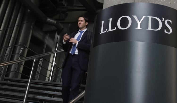A office worker walks from the Lloyd's Building, the home of the insurance institution Lloyd's of London on September 25 2008 in London, England. (Matt Cardy/Getty Images)