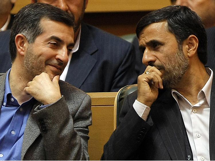 Iranian President Mahmoud Ahmadinejad (R) talks with aide Esfandiar Rahim Mashaie (L) at an  Iranian expatriates summit in Tehran, April 14, 2009. (Behrouz Mehri/AFP/Getty Images)