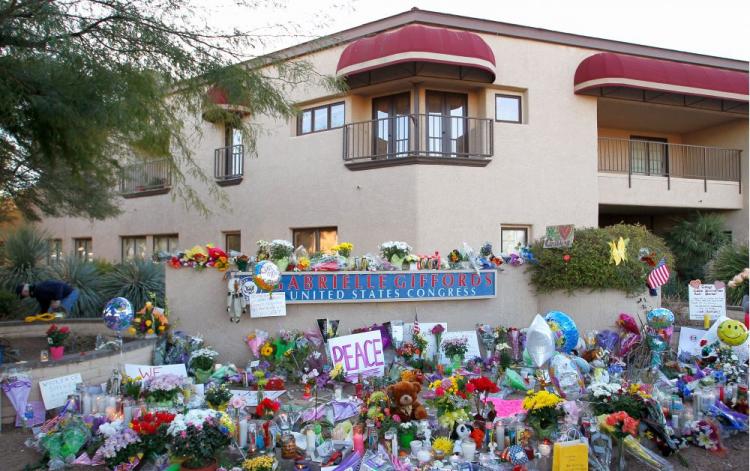 A memorial is set outside of the district office of Rep. Gabrielle Gifford (D-Ariz.) a day after a gunman opened fire on a group of people in Tucson, Ariz. The suspect, 22-year-old Jared Lee Loughner, shot Gifford in the head during a public event titled  (Kevin C. Cox/Getty Images)
