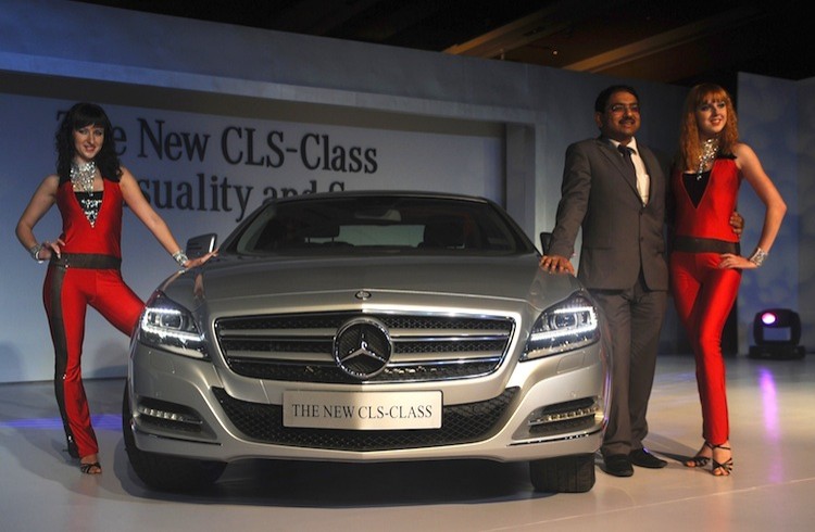 India's Mercedes-Benz's sales and marketing director, Debashis Mitra (2R), and models pose with the new CLS 350 during its launch in Mumbai on Sept. 8. In India, the three major car sales companies reported significant nose dives in August sales. (Punit Paranjpe/AFP/Getty Images)