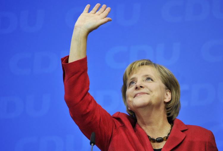 German Chancellor and leader of the Christian Democratic Union (CDU) Angela Merkel waves during the election evening after parliamentary elections at the CDU headquarters in Berlin on last Sunday. (Joerg Koch/AFP/Getty Images )