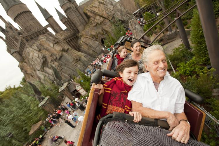 Michael Douglas and wife Catherine Zeta-Jones along with their children Dylan, 10, and Carys, 7, fly over The Wizarding World of Harry Potter and past Hogwarts Castle while riding Flight of the Hippogriff at Universal Orlando Resort on November 27, 2010. (Matt Stroshane/Universal Studios via Getty Images)