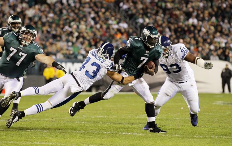 Michael Vick #7 of the Philadelphia Eagles runs the ball against Aaron Francisco #43 and Dwight Freeney #93 of the Indianapolis Colts on Sunday at Lincoln Financial Field in Philadelphia, Pennsylvania. (Jim McIsaac/Getty Images)