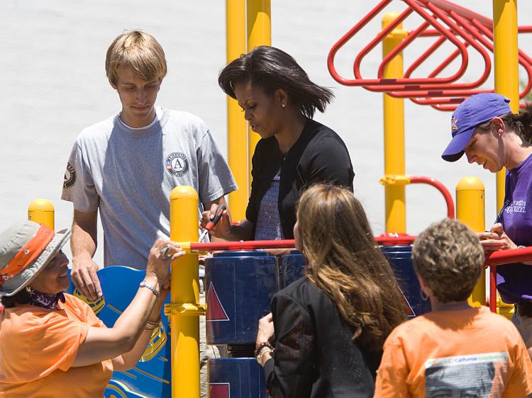 FIRST LADIES VOLUNTEER: U.S. First Lady Michelle Obama (center top) and California First Lady Maria Shriver (center bottom) help build a play ground at the Bret Harte Elementary School. (Kimberly White/Getty Images)