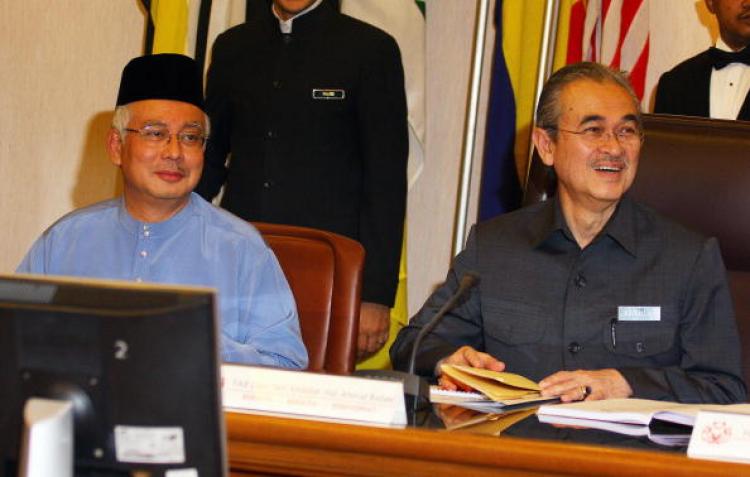 Malaysian Prime Minister Abdullah Ahmad Badawi (R) smiles while his Deputy Prime Minister Najib Tun Razak looks on before the United Malays National Organisation (UMNO) supreme council special meeting in Kuala Lumpur.  (Kamarul Akhir/AFP/Getty Images)