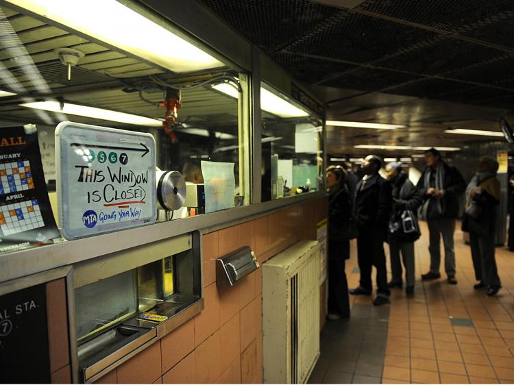 Commuters wait in line to purchase subway passes at a subway station in New York.  (Emmanuel Dunand/AFP/Getty Images)